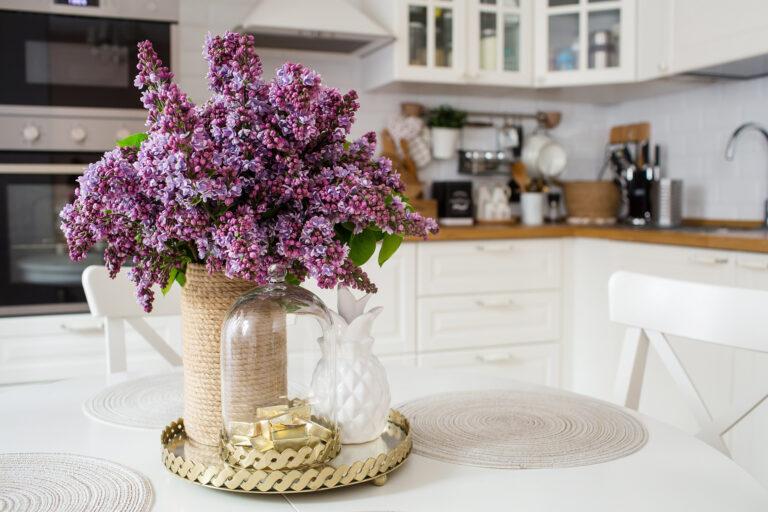 Beautiful, purple lilac bouquet on a gold tray on the table